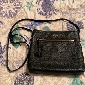 Black pebbled 100% cow leather Kate Spade cross body bag with gold accents.